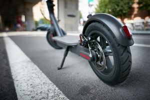 Black electric scooter parked on the street